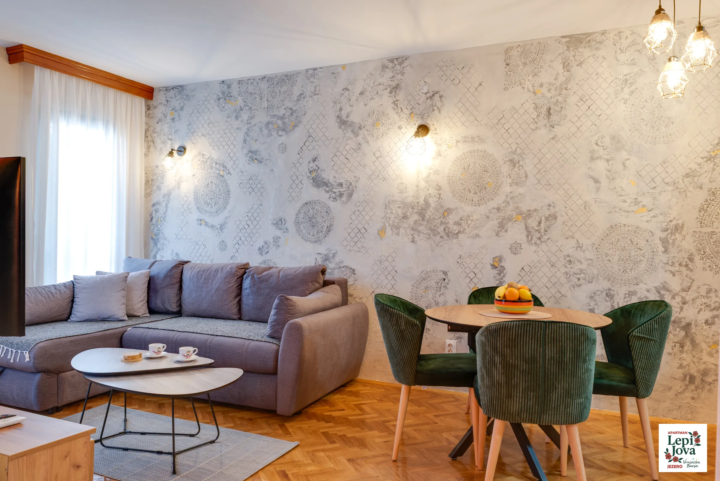 Dnevni boravak apartmana Jezero sa udobnim trosedom i trpezarijskim stolom